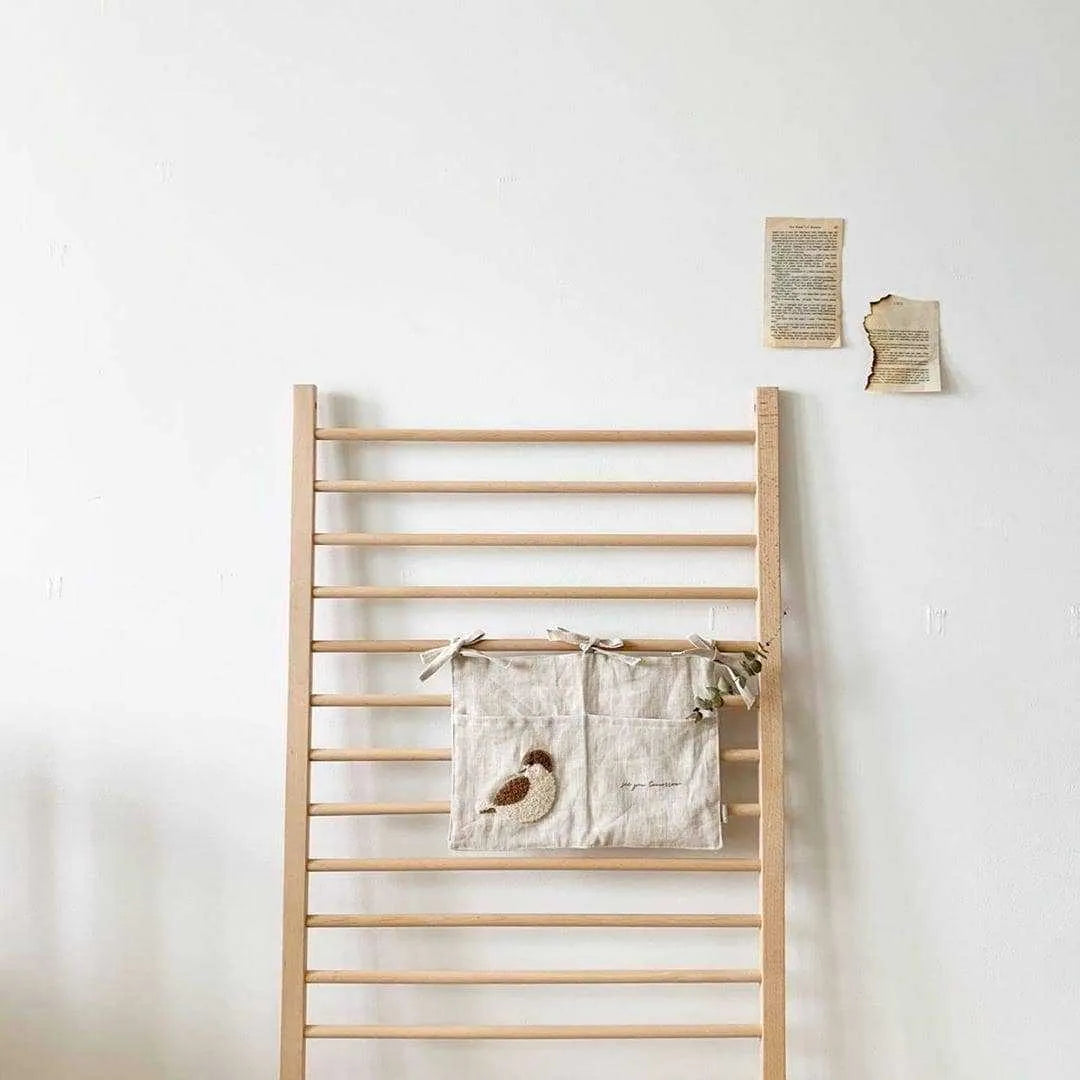 Khaki coloured cotton linen hanging storage bag with one pocket, designed for bedside organisation.