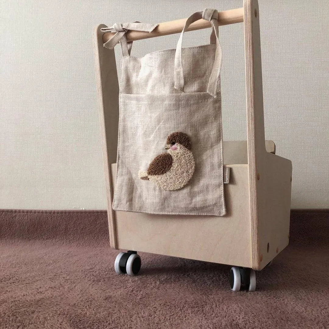 Khaki coloured cotton linen hanging storage bag with one pocket, designed for bedside organisation.
