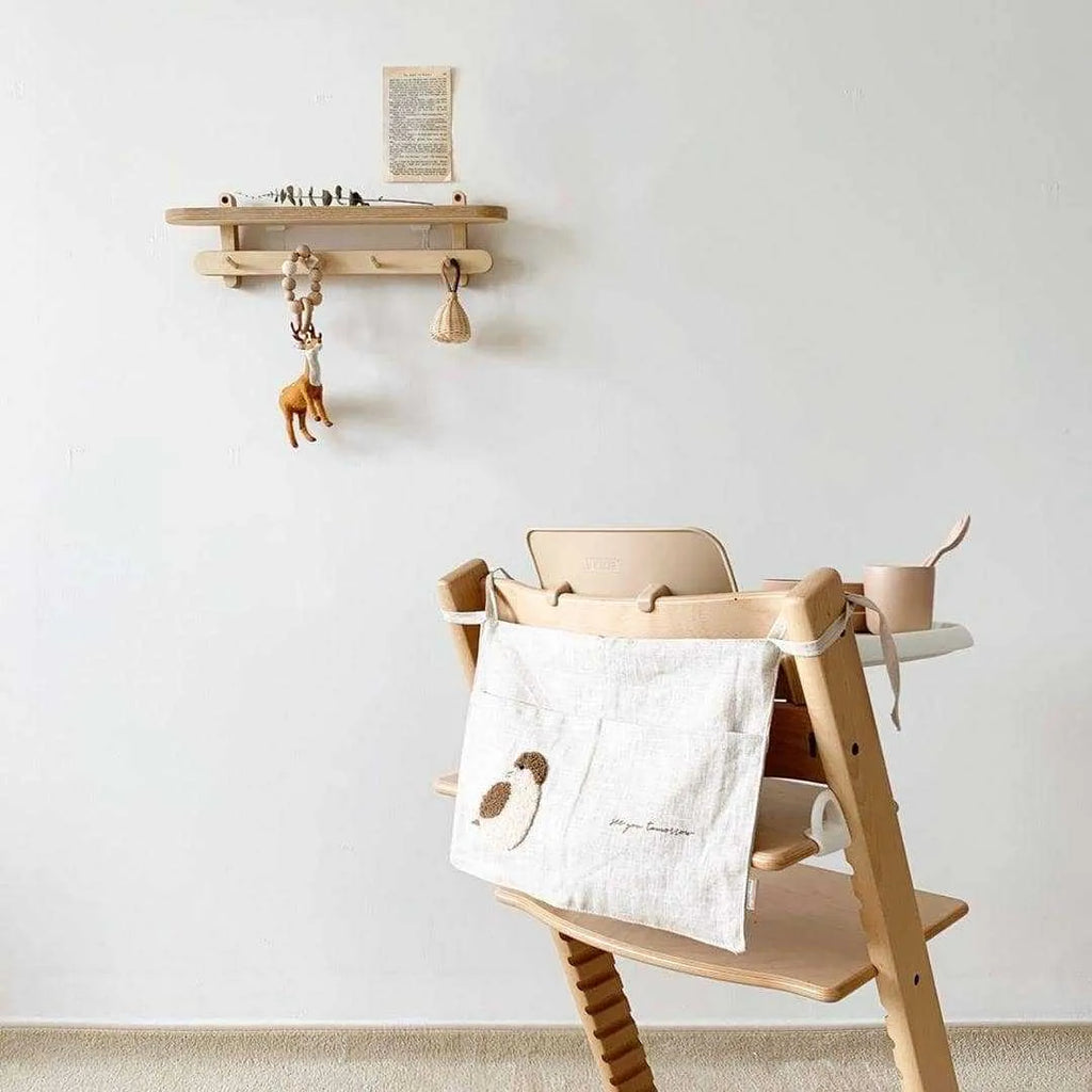 Khaki coloured cotton linen hanging storage bag with one pocket, designed for bedside organisation.