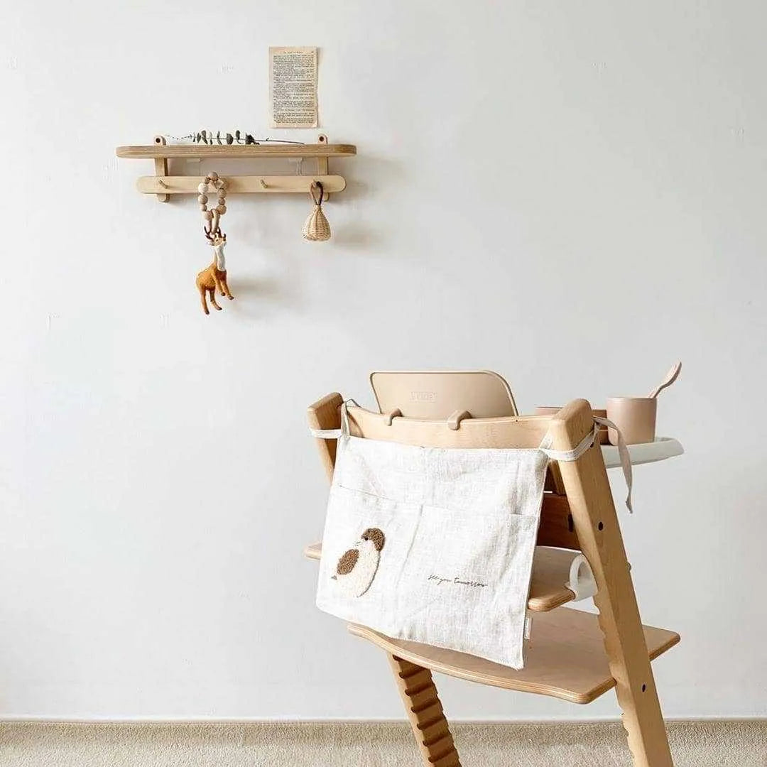 Khaki coloured cotton linen hanging storage bag with one pocket, designed for bedside organisation.