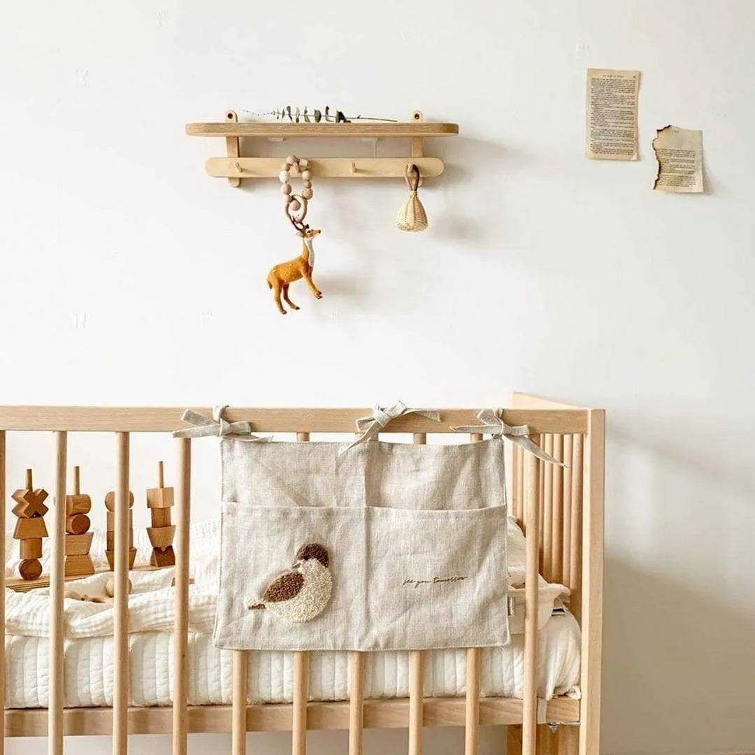 Khaki coloured cotton linen hanging storage bag with one pocket, designed for bedside organisation.