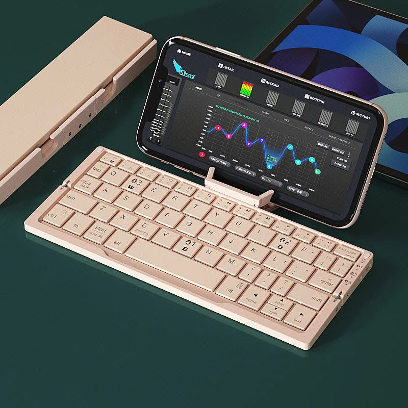 Silver white folding Bluetooth keyboard open with stand holding a smartphone, shown next to its closed compact size.