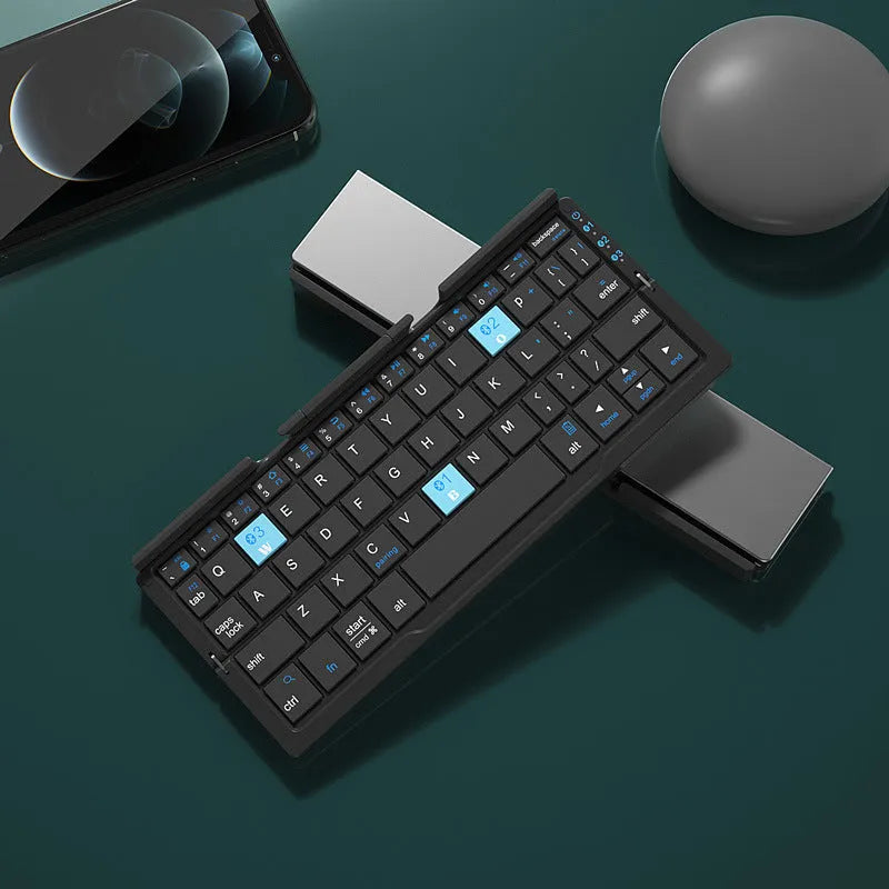 Silver white folding Bluetooth keyboard open with stand holding a smartphone, shown next to its closed compact size.