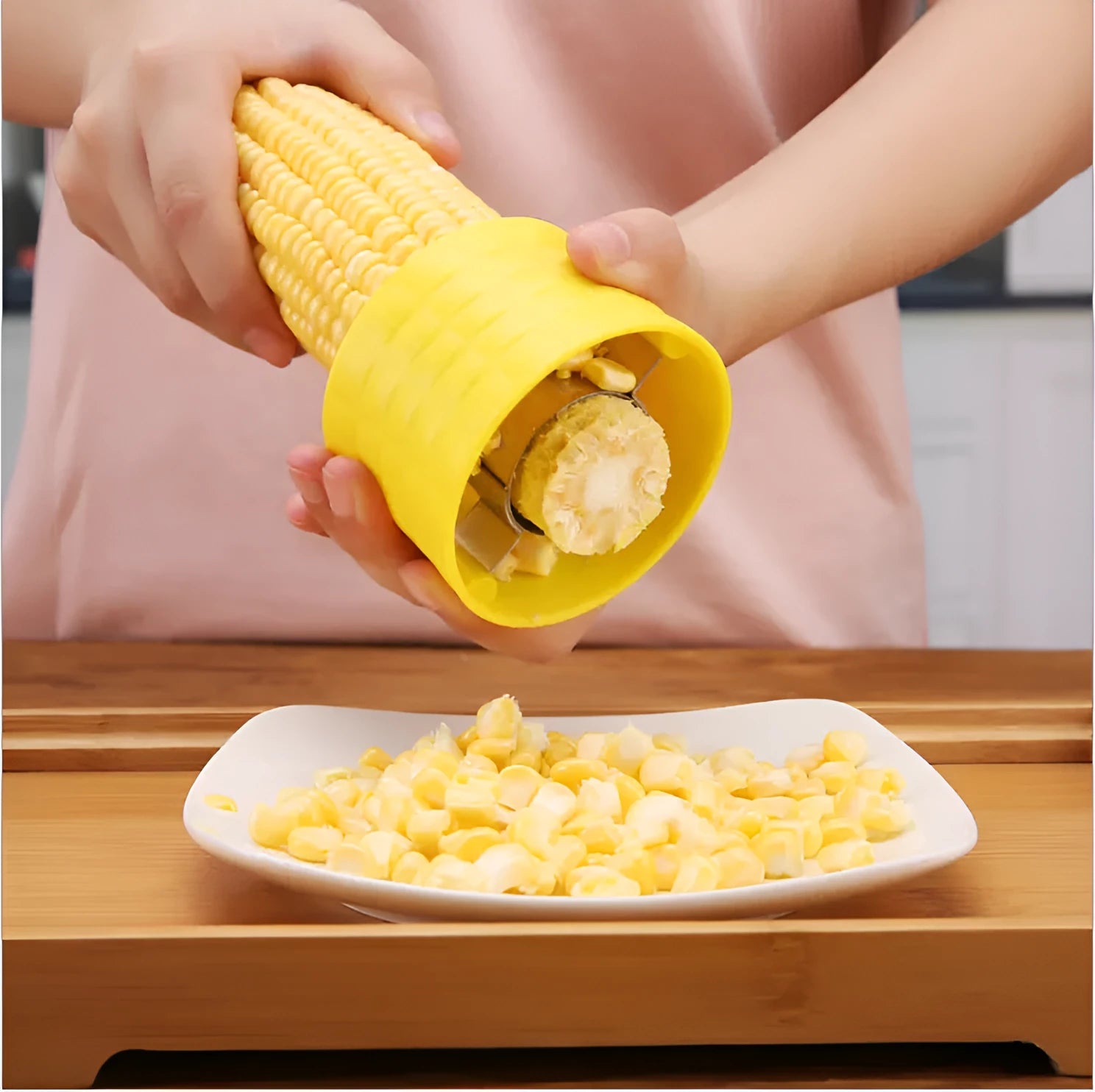Yellow manual corn grinder thresher kitchen gadget with corn kernel shaped handle.