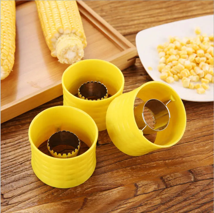 Yellow manual corn grinder thresher kitchen gadget with corn kernel shaped handle.