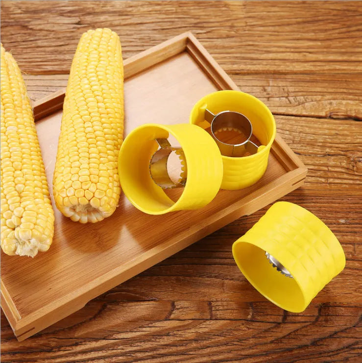 Yellow manual corn grinder thresher kitchen gadget with corn kernel shaped handle.
