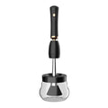 Black makeup brush cleaning machine with silicone head and portable plastic handle on white background
