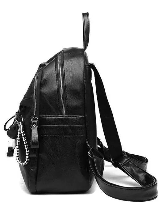 Black PU leather backpack with double straps, shown with and without a decorative pendant.