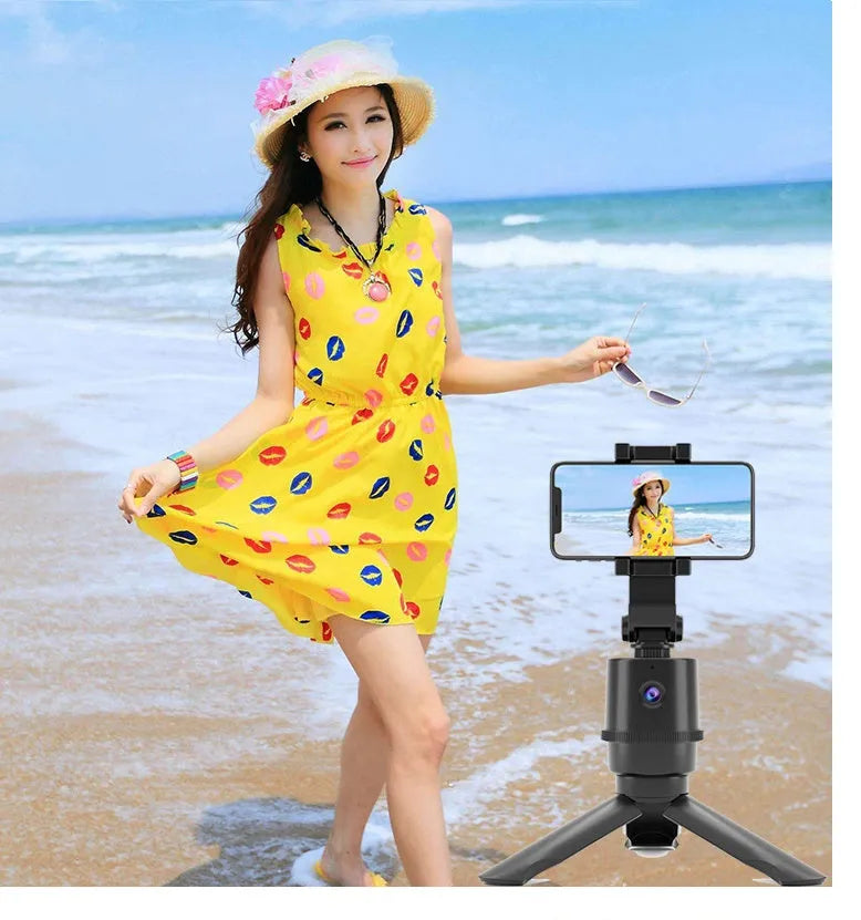 360 degree AI tracking pan tilt smartphone bracket on a table, showing phone holder and rotation base.