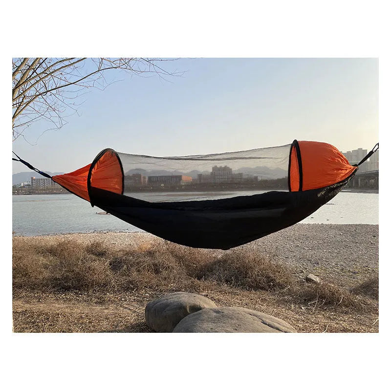 Automatic quick-opening double hammock with mosquito net and sun shades in Army Green Orange set up between trees outdoors
