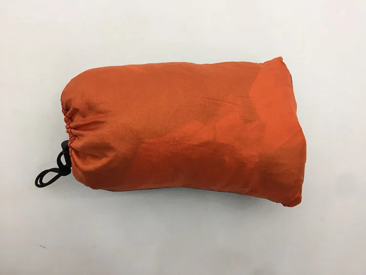 Automatic quick-opening double hammock with mosquito net and sun shades in Army Green Orange set up between trees outdoors