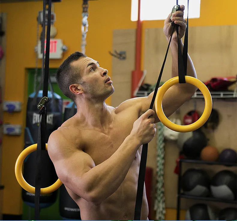 Black rubber encapsulated gymnastics rings with ropes and gloves for pull-ups indoor fitness training