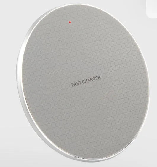 Black aluminum wireless charging pad with phone showing charging indicator light