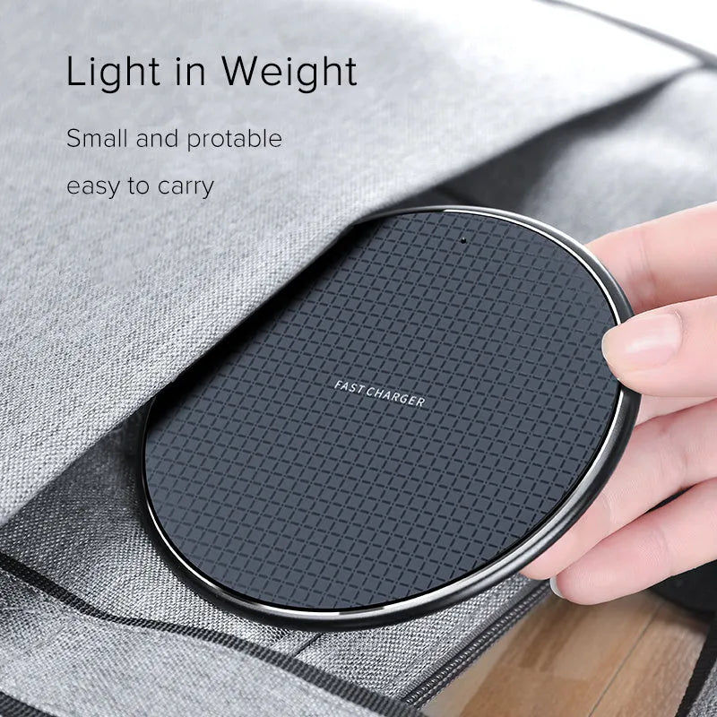 Black aluminum wireless charging pad with phone showing charging indicator light