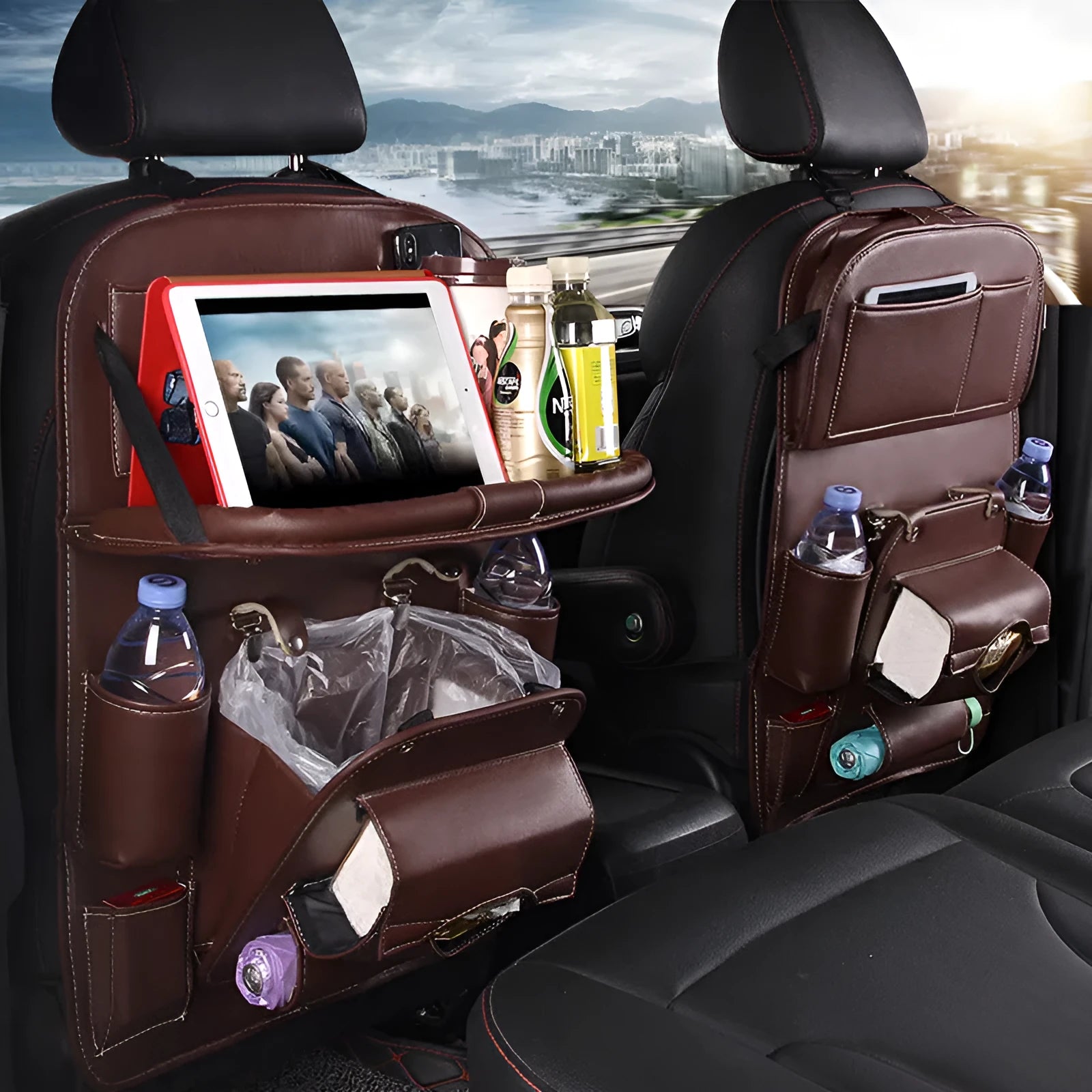 Black PU leather car seat back organiser with multiple pockets hanging on a car headrest.
