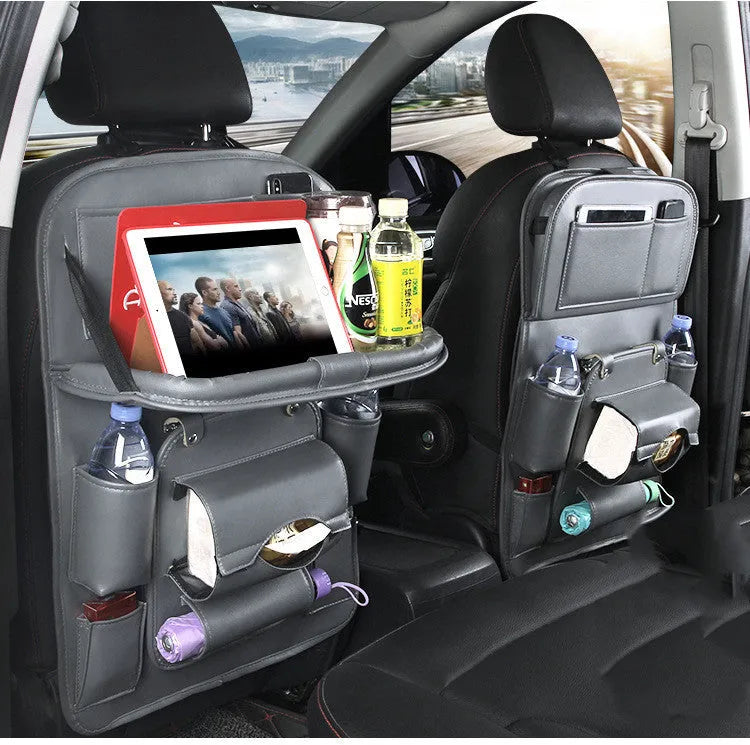 Black PU leather car seat back organiser with multiple pockets hanging on a car headrest.