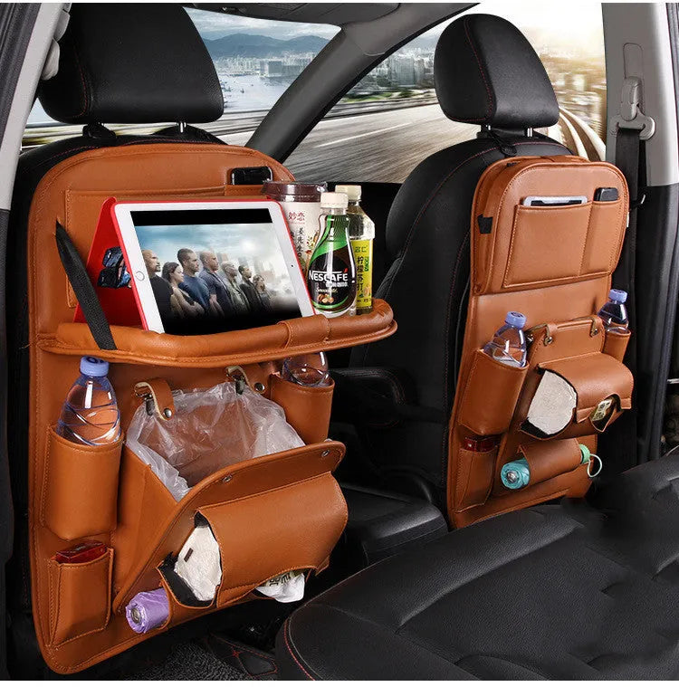 Black PU leather car seat back organiser with multiple pockets hanging on a car headrest.