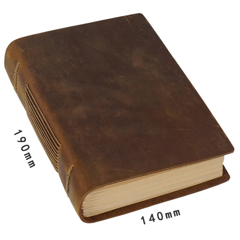 Brown handmade cowhide leather notebook with 200 pages, 19x14cm paper size, lying open on a wooden desk