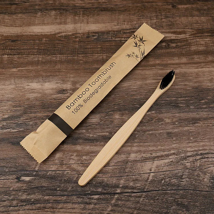 10 multi-coloured natural bamboo toothbrushes with soft charcoal bristles arranged on a white background