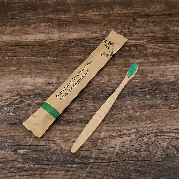 10 multi-coloured natural bamboo toothbrushes with soft charcoal bristles arranged on a white background