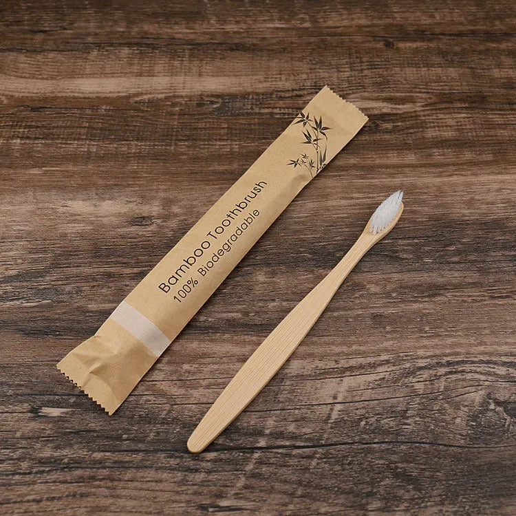 10 multi-coloured natural bamboo toothbrushes with soft charcoal bristles arranged on a white background