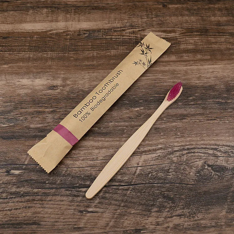 10 multi-coloured natural bamboo toothbrushes with soft charcoal bristles arranged on a white background