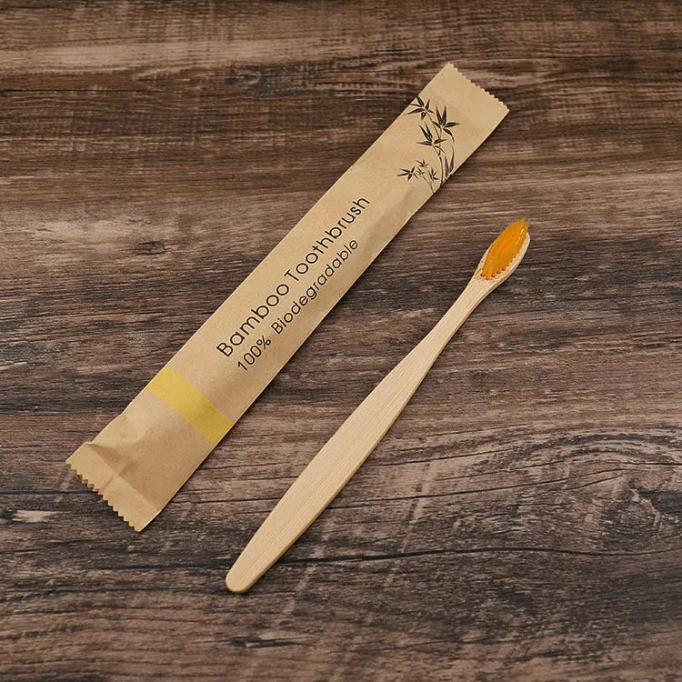 10 multi-coloured natural bamboo toothbrushes with soft charcoal bristles arranged on a white background