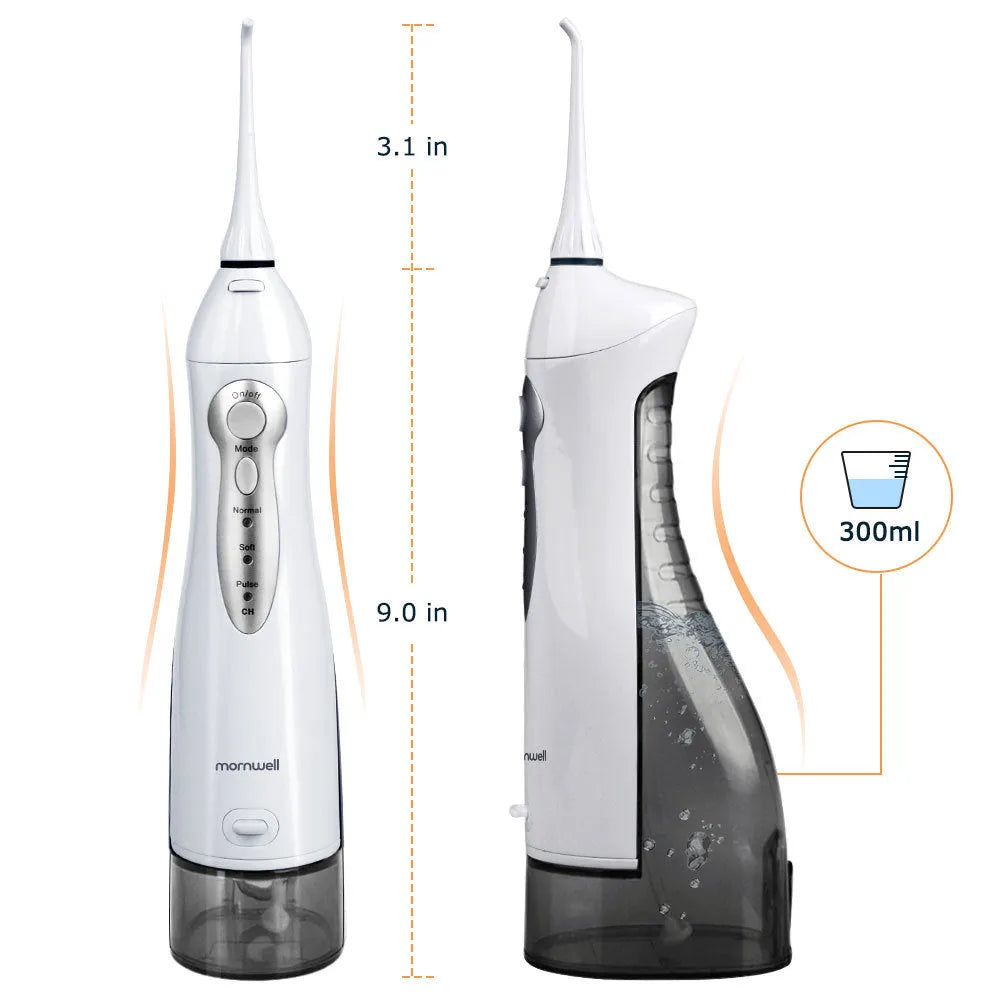 Portable white oral irrigator water flosser with large water tank and four coloured nozzles on a bathroom counter.