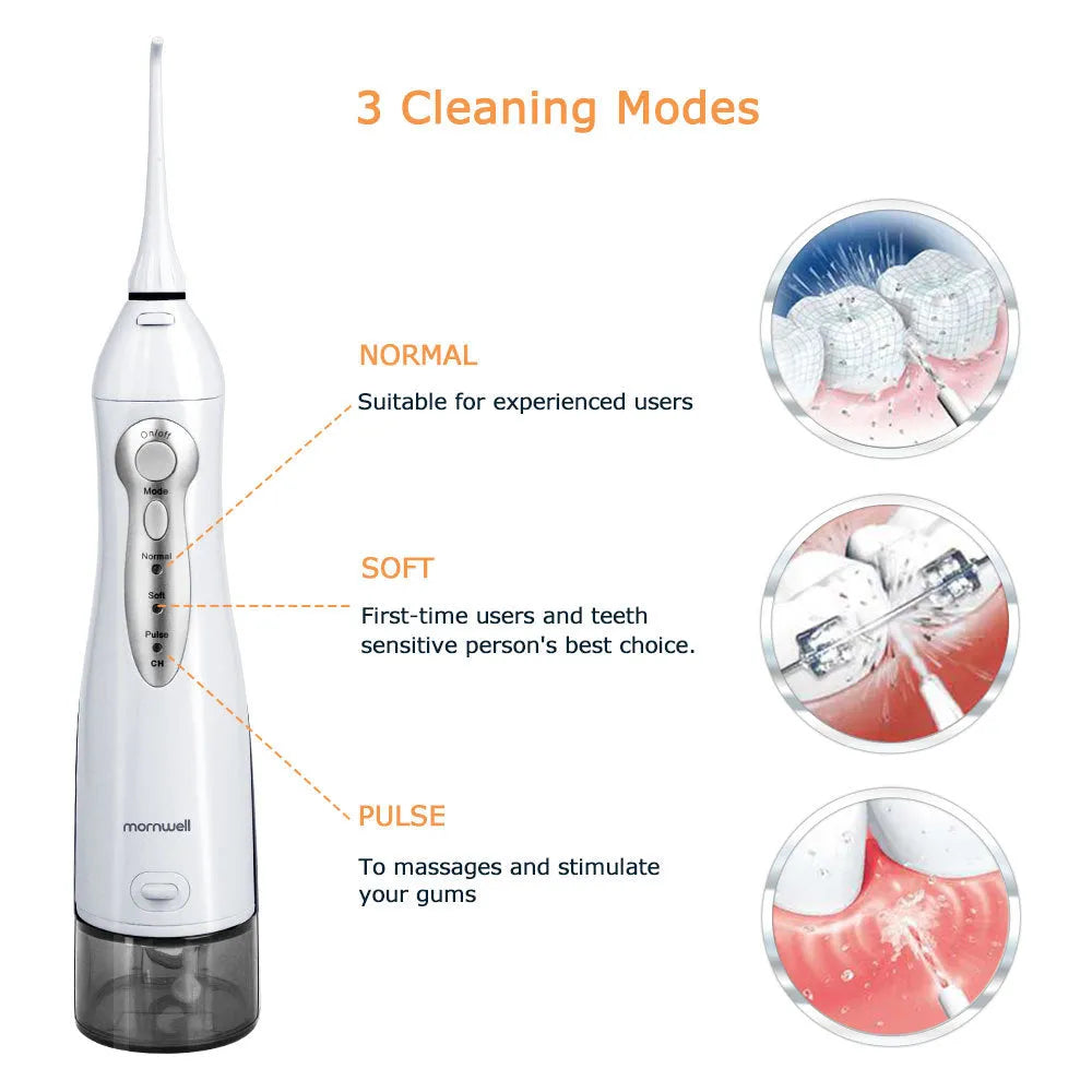 Portable white oral irrigator water flosser with large water tank and four coloured nozzles on a bathroom counter.
