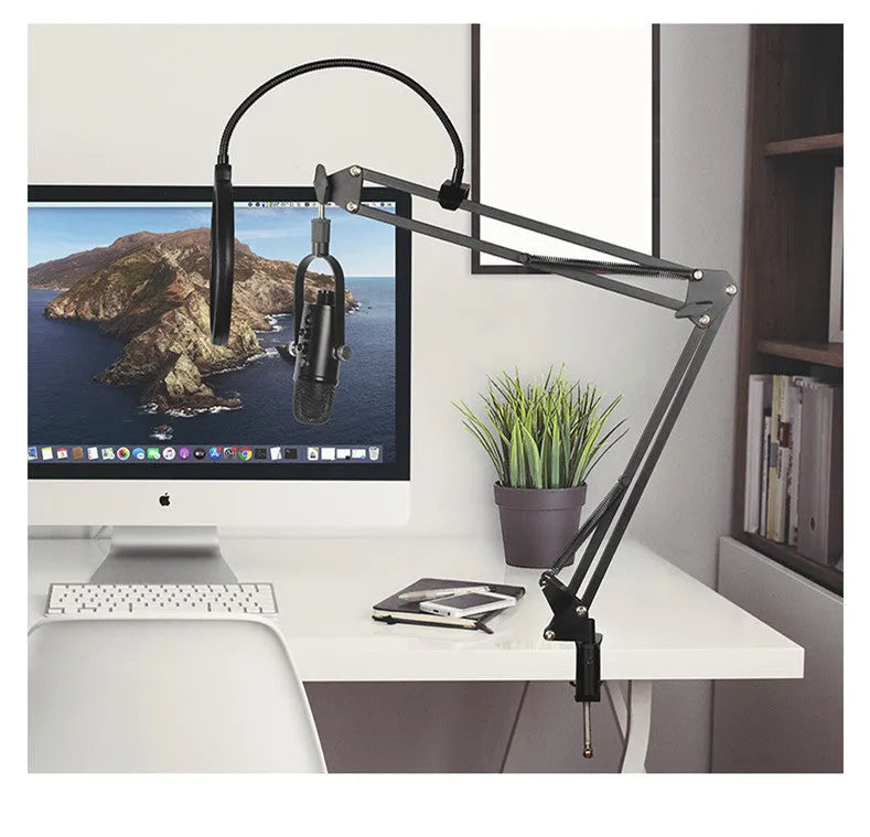Black USB condenser microphone with metal stand and foam pop filter on a desktop