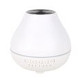 White round Soho & Co Bluetooth aroma diffuser emitting mist, with multi-colour LED glow and UK plug.