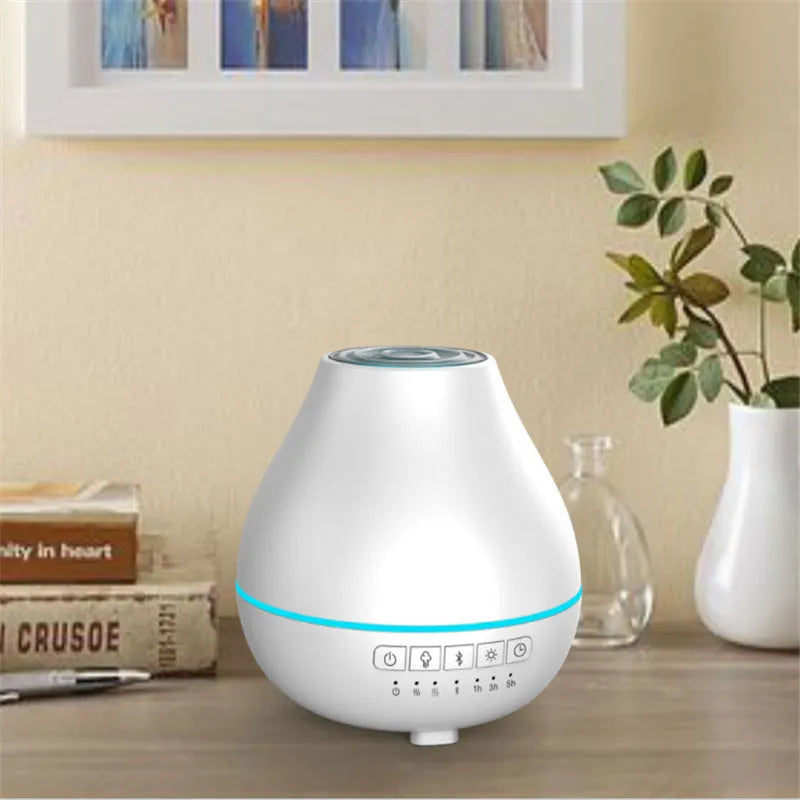 White round Soho & Co Bluetooth aroma diffuser emitting mist, with multi-colour LED glow and UK plug.