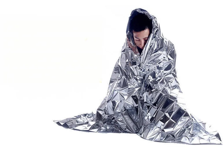 Gold silver emergency blanket made from PET film with reflective coating, 130x210cm size, for outdoor survival and rescue.