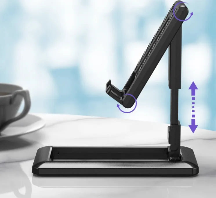 A folded and unfolded view of a black retractable mobile phone desktop stand on a wooden desk.