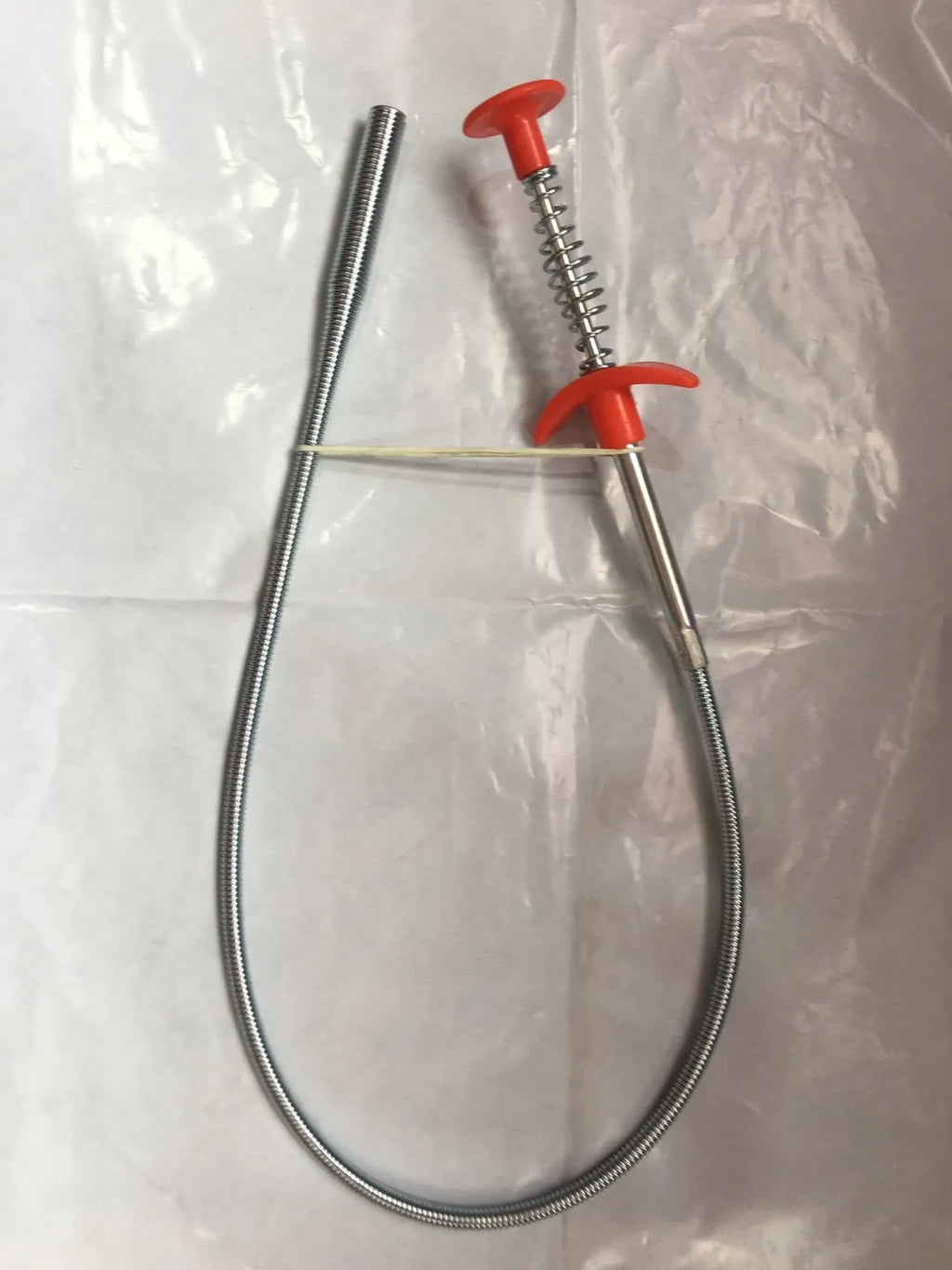 Flexible 60cm long sewer dredger spring cleaning tool with a grip handle for unblocking sink drains.