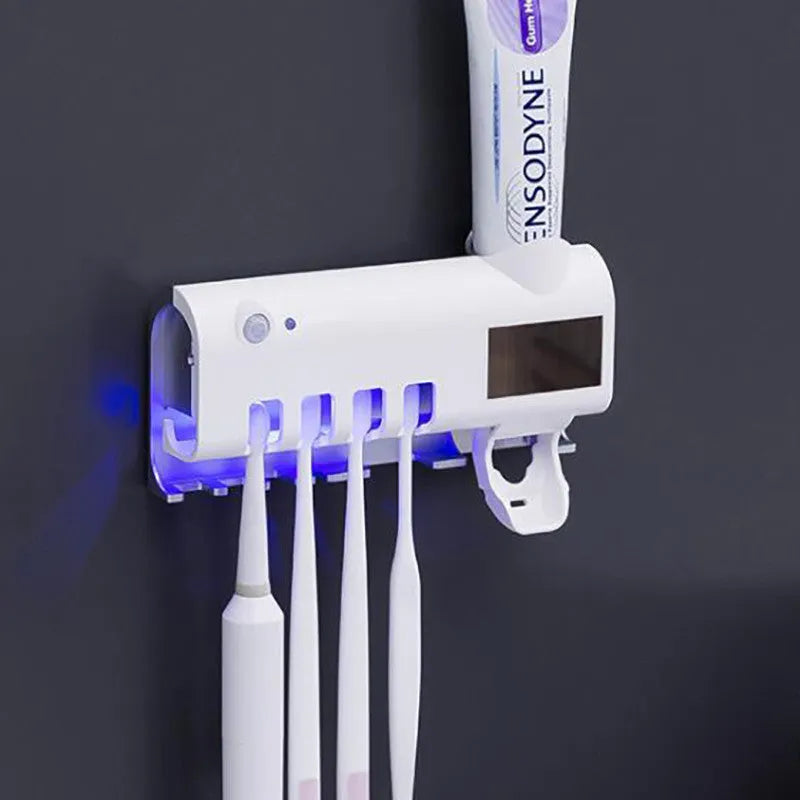 Wall-mounted UV toothbrush steriliser with automatic toothpaste squeezer in black or white colour