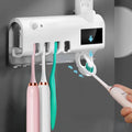 Wall-mounted UV toothbrush steriliser with automatic toothpaste squeezer in black or white colour