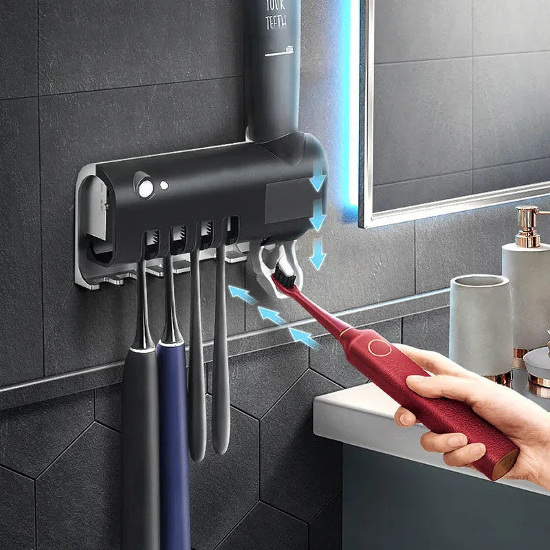 Wall-mounted UV toothbrush steriliser with automatic toothpaste squeezer in black or white colour