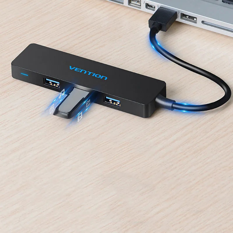 Black Wei Xun 4-port USB 3.0 hub with a short cable connected to a laptop