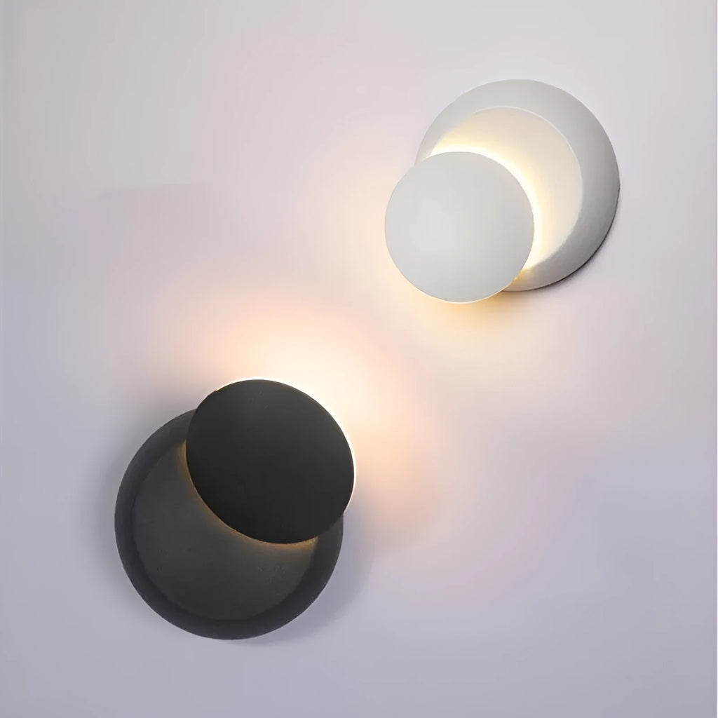 Rotating lunar eclipse LED wall lamp in black aluminium shade mounted on wall with pull-wire switch