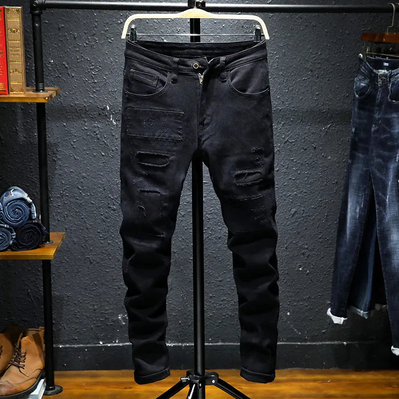 Men's black ripped stretch straight leg jeans with distressed detailing and zipper fly
