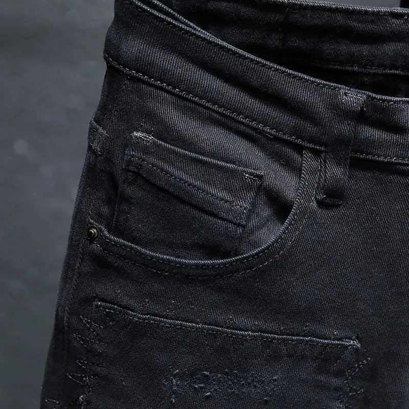 Men's black ripped stretch straight leg jeans with distressed detailing and zipper fly