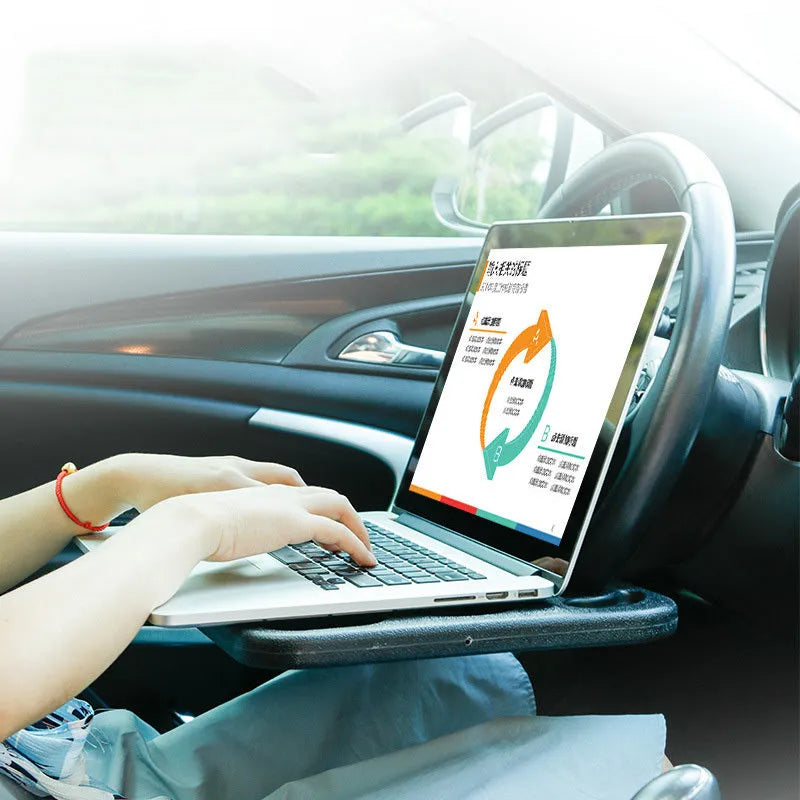Large black HDPE car steering wheel tray measuring 42x28cm, placed over a steering wheel as a flat desk surface.