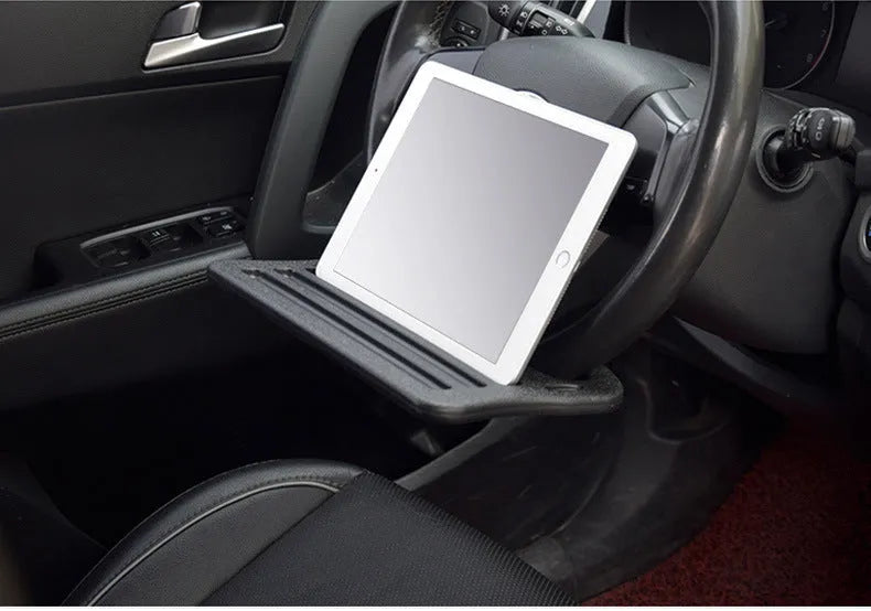 Large black HDPE car steering wheel tray measuring 42x28cm, placed over a steering wheel as a flat desk surface.