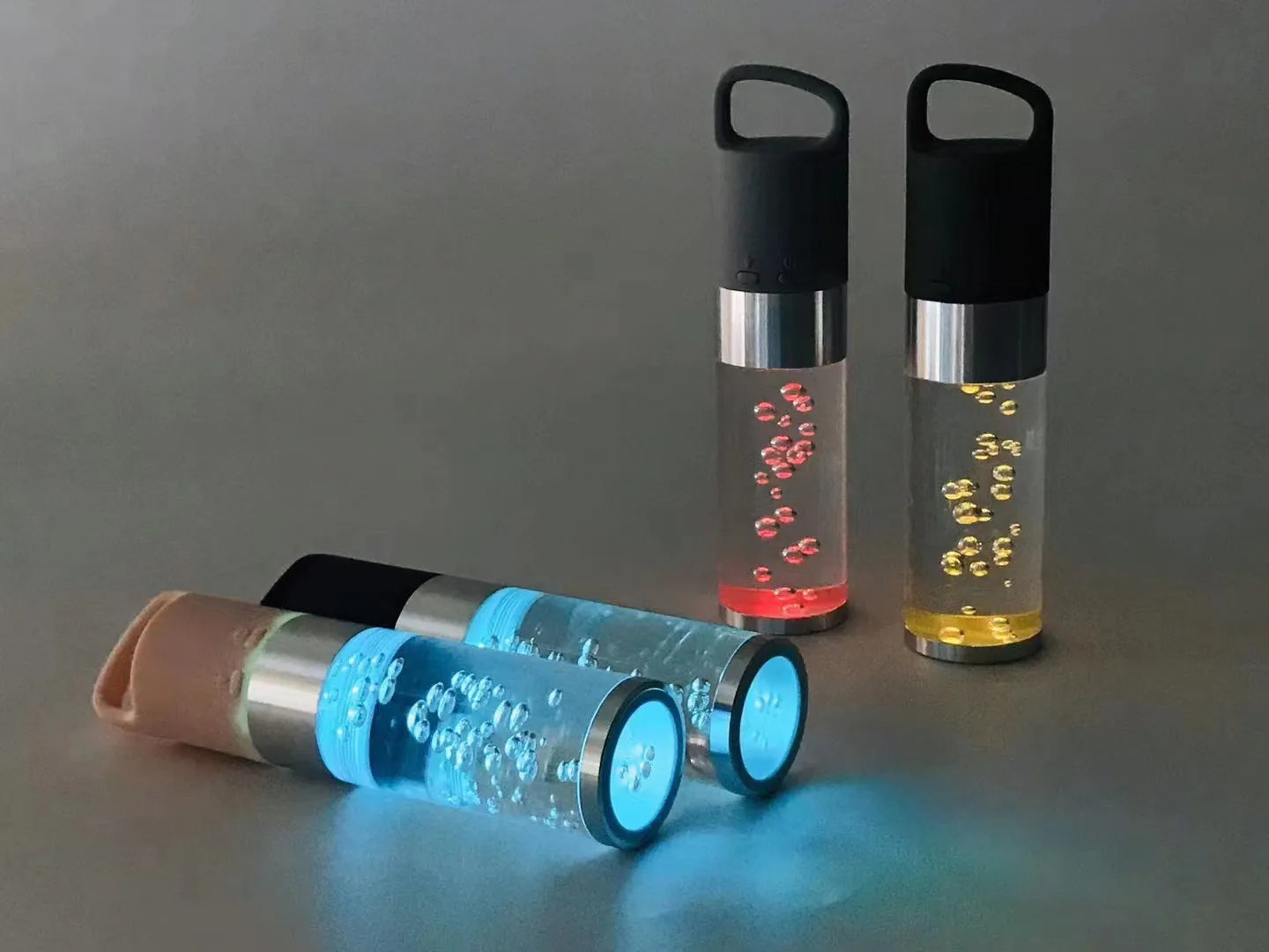 Pink portable Bluetooth speaker with a crystal light and carry handle on a white background.