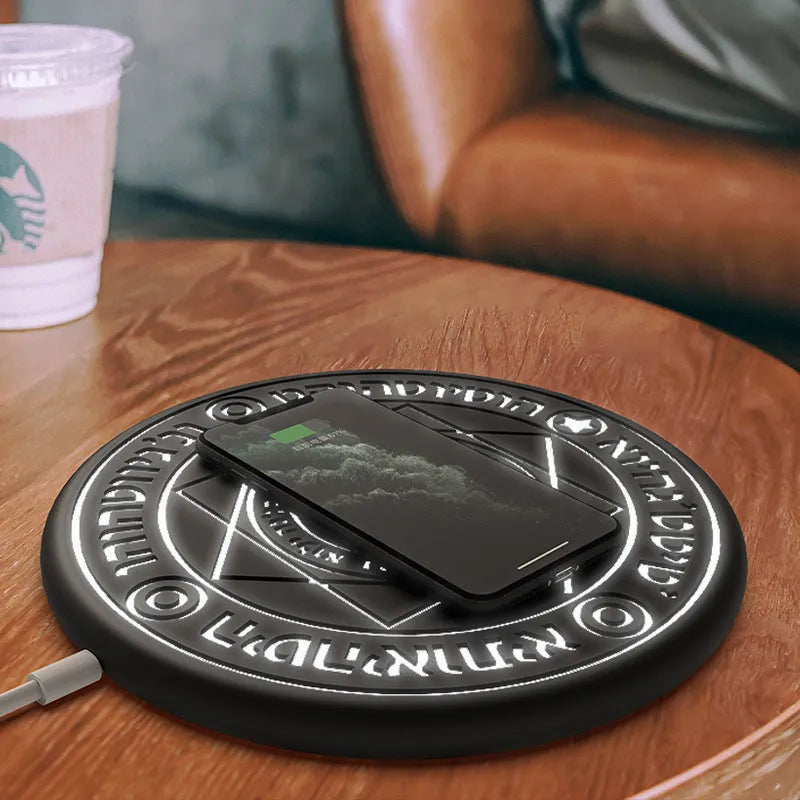 Square black 10W fast wireless charging pad with glowing magic array pattern for Qi phones.
