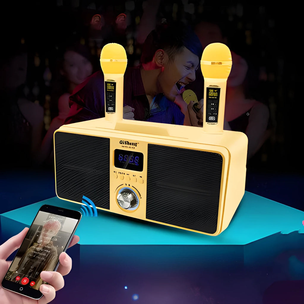 Black and gold Bluetooth karaoke speaker with two wireless microphones on a table.