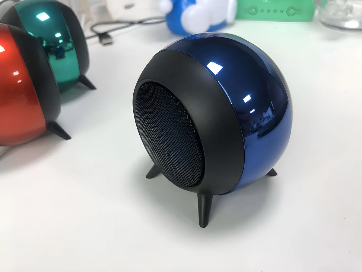 Mini metal Bluetooth speaker in black with button controls and metal grille