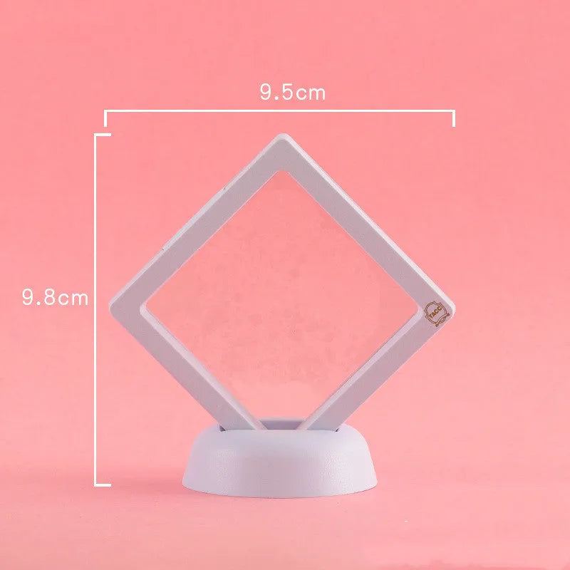 3D floating display case holding a coin suspended between transparent membrane sheets, black frame