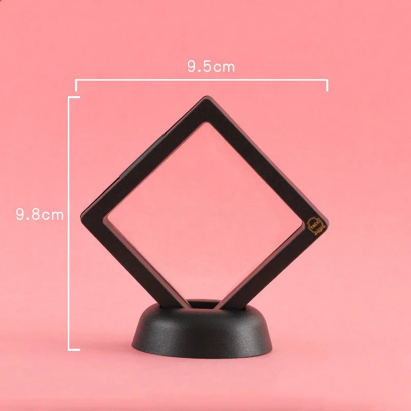 3D floating display case holding a coin suspended between transparent membrane sheets, black frame